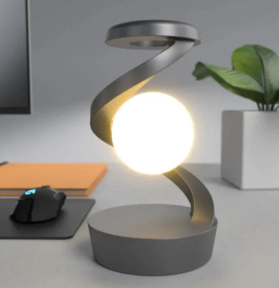Rotating Moon Desk Lamp with Wireless Charging featuring levitating moon orb and sleek spiral metal frame for ambient lighting