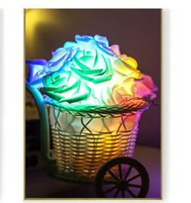 LED Rose Flower String Lights glowing with soft multicolor rose-shaped bulbs inside a decorative wire cart display
