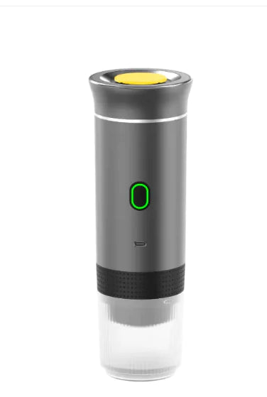 Wireless Capsule Coffee Maker in matte black with yellow button and glowing green power icon on white background