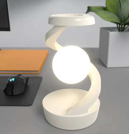 Rotating Moon Desk Lamp with Wireless Charging featuring a glowing orb suspended by a curved white frame for elegant ambient lighting
